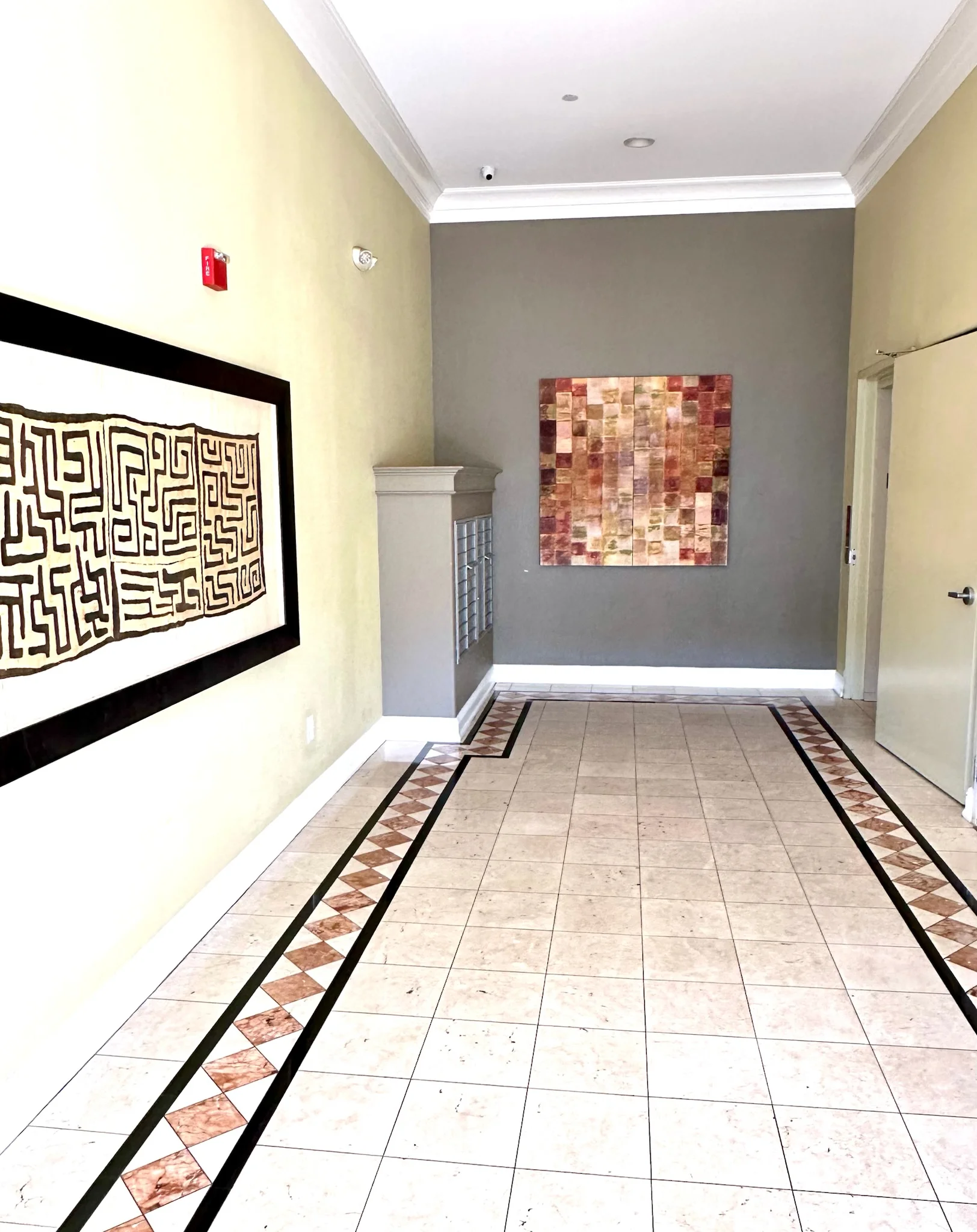 Elegant marble-tiled lobby with curated artwork at Monterey Terrace Apartments in downtown Gilroy CA